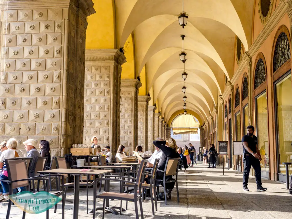 restaurants at a covered walkway bologna emilia romagna italy - laugh travel eat